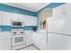 White kitchen with stainless steel appliances and blue walls at 5750 Oyster Catcher Dr. # 932, North Myrtle Beach, SC 29582