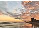 Stunning sunset over the ocean with beach and building in the distance at 5825 Catalina Dr. # 1234, North Myrtle Beach, SC 29582