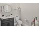 Modern powder room with dark vanity and white toilet at 5913 Country Club Dr., Myrtle Beach, SC 29577