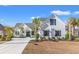 Two-story farmhouse with white siding, dark accents, and palm trees at 5913 Country Club Dr., Myrtle Beach, SC 29577