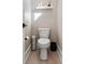 Clean powder room with toilet, floating shelf, and minimalist decor at 5913 Country Club Dr., Myrtle Beach, SC 29577