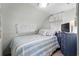 Cozy bedroom with blue striped bedding and a dresser at 6001 - 1861 S Kings Hwy., Myrtle Beach, SC 29575