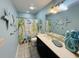 Bathroom with a beach-themed shower curtain and dark vanity at 6001 - 6004 S Kings Hwy., Myrtle Beach, SC 29575