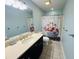 Clean bathroom with flamingo shower curtain and dark vanity at 6001 - 6004 S Kings Hwy., Myrtle Beach, SC 29575