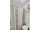 Small bathroom with shower stall, toilet and striped curtain at 601 37Th Ave. N # C, Myrtle Beach, SC 29577