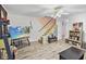 Living room with staircase, flat-screen TV, and wood flooring at 601 37Th Ave. N # C, Myrtle Beach, SC 29577