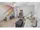 Light-filled living room with hardwood floors, comfortable seating, and built-in shelving at 601 37Th Ave. N # C, Myrtle Beach, SC 29577