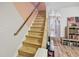 Wooden staircase with brass railing and stone accent wall at 601 37Th Ave. N # C, Myrtle Beach, SC 29577