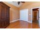 Bedroom with hardwood floors, double doors to closet, and adjacent bathroom at 604 Ellis Dr., Conway, SC 29526