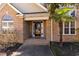 Brick front porch with a glass entry door at 604 Ellis Dr., Conway, SC 29526