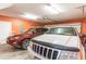 Two SUVs parked in a spacious garage with painted walls and an automatic garage door opener at 604 Ellis Dr., Conway, SC 29526