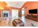 Living room with tile floors, fireplace, and view to sunroom at 604 Ellis Dr., Conway, SC 29526