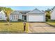 Gray house with a white garage door and a neatly landscaped lawn at 605 West Perry Rd., Myrtle Beach, SC 29579