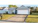 Gray house with a white garage door and a neatly landscaped lawn at 605 West Perry Rd., Myrtle Beach, SC 29579