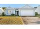 Gray siding house with attached garage and grassy front yard at 605 West Perry Rd., Myrtle Beach, SC 29579