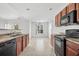 Eat-in kitchen with dark wood cabinets and black appliances at 605 West Perry Rd., Myrtle Beach, SC 29579