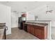 Modern kitchen with dark wood cabinets, black appliances, and tile flooring at 605 West Perry Rd., Myrtle Beach, SC 29579