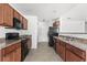 Modern kitchen with dark wood cabinets and black appliances at 605 West Perry Rd., Myrtle Beach, SC 29579