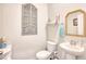 Stylish powder room with pedestal sink, decorative wall art, and a white toilet at 623 Meadowgrass Ct., Myrtle Beach, SC 29588