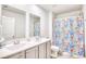 Bathroom boasts double vanity, and a shower with a patterned curtain at 623 Meadowgrass Ct., Myrtle Beach, SC 29588