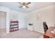 Bright home office features built-in shelving, desk, and ceiling fan at 623 Meadowgrass Ct., Myrtle Beach, SC 29588