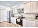 Well-equipped kitchen boasting stainless steel appliances and stylish gray cabinetry at 623 Meadowgrass Ct., Myrtle Beach, SC 29588