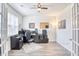 Home office with a large desk, ample natural light, and wood-look flooring at 623 Meadowgrass Ct., Myrtle Beach, SC 29588