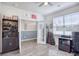 Bright home office featuring built-in shelving, a spacious desk, and a ceiling fan at 623 Meadowgrass Ct., Myrtle Beach, SC 29588