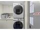 Stackable washer and dryer in a well-lit laundry room at 645 Sandpiper Run Retreat Beach Circle, Pawleys Island, SC 29585