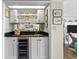 Elegant wet bar with wine cooler, glass shelving, and dark countertop at 645 Sandpiper Run Retreat Beach Circle, Pawleys Island, SC 29585