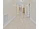 Long hallway with tile floors and access to stairs at 65 Harbourreef Dr., Pawleys Island, SC 29585