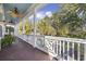 Spacious porch with white railings and ceiling fans, overlooking the neighborhood at 65 Harbourreef Dr., Pawleys Island, SC 29585