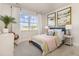 Bright bedroom with a large window, neutral walls, stylish decor, and a comfortable bed with colorful accents at 705 Choctaw Dr., Conway, SC 29526