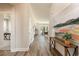 Inviting hallway with wood floors that leads into a living space and includes art on the wall and an entry to another room at 705 Choctaw Dr., Conway, SC 29526