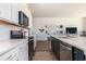 Modern kitchen with white cabinets, quartz countertops, and stainless steel appliances at 705 Choctaw Dr., Conway, SC 29526