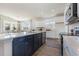Modern kitchen featuring white cabinets, stainless appliances, and a view into the dining and living areas at 705 Choctaw Dr., Conway, SC 29526