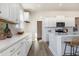 Bright kitchen featuring white cabinetry, stainless appliances, an island with seating, and decorative backsplash at 705 Choctaw Dr., Conway, SC 29526