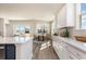 Open-concept kitchen with white cabinets, stainless steel appliances, and a view of a serene outdoor area at 705 Choctaw Dr., Conway, SC 29526