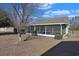 House exterior view, screened porch and landscaping at 7570 Johnson Rd., Myrtle Beach, SC 29588