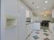 Galley kitchen with white cabinets and an adjacent dining area at 7570 Johnson Rd., Myrtle Beach, SC 29588