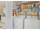 Bright laundry room with washer, dryer, and ample storage shelving at 7570 Johnson Rd., Myrtle Beach, SC 29588