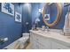 Elegant powder room with a white vanity and blue walls at 8058 Verona Dr., Myrtle Beach, SC 29572