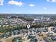 A neighborhood aerial view shows many houses, streets, lakes, and forest from above on a sunny day at 817 Old Castle Loop, Myrtle Beach, SC 29579