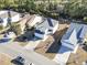 Aerial view of a light gray two-story house with a gray roof, driveway, and green surroundings at 817 Old Castle Loop, Myrtle Beach, SC 29579