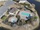 Aerial view of a community pool with a hot tub, playground, parking, and walking trail at 817 Old Castle Loop, Myrtle Beach, SC 29579