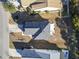 An aerial view of a house with a gray roof, a driveway and surrounded by green grass and other houses at 817 Old Castle Loop, Myrtle Beach, SC 29579