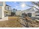 A home's sunny backyard features a small garden with a hanging swing seat and a front lawn at 817 Old Castle Loop, Myrtle Beach, SC 29579