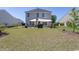 Spacious backyard featuring a lawn and patio with a sunshade at 817 Old Castle Loop, Myrtle Beach, SC 29579