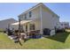 Side view of a backyard, covered patio, a grill and outdoor seating at 817 Old Castle Loop, Myrtle Beach, SC 29579