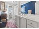 Bright bathroom featuring a blue accent wall, large vanity, and natural light, plus a shower and window at 817 Old Castle Loop, Myrtle Beach, SC 29579